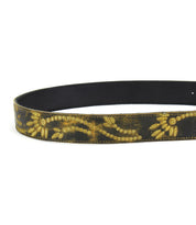 Introducing the Mohawk by Bed Stu: A distressed leather belt featuring an intricate gold floral design along its length.