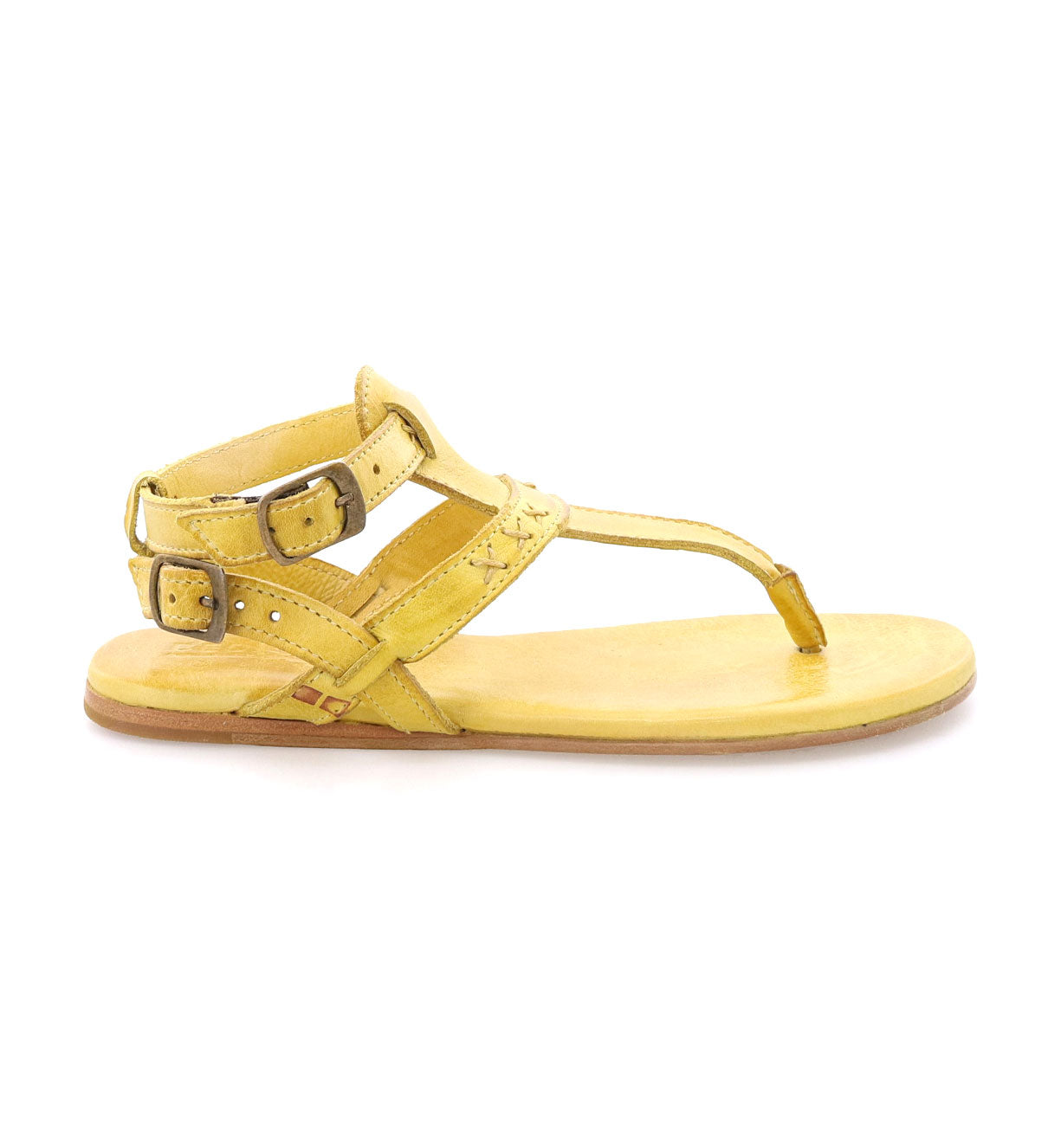A pair of Moon yellow sandals with buckles and straps by Bed Stu.