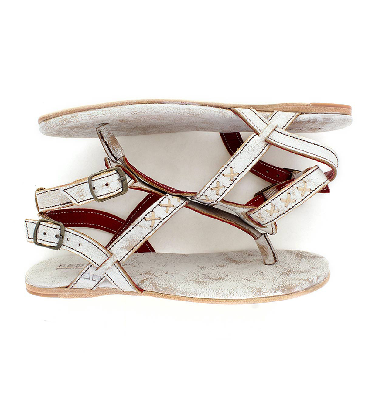 A pair of Moon sandals with red straps from the brand Bed Stu.