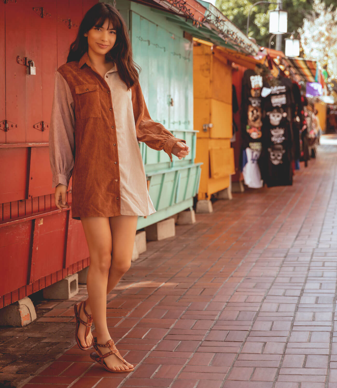 A woman in a tan dress walking down a sidewalk wearing Moon shoes by Bed Stu.