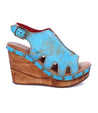 A women's Naiya blue wedge sandal with a wooden platform by Bed Stu.
