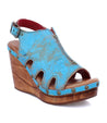 A women's blue wedge sandal with wooden wedges called the Naiya by Bed Stu.