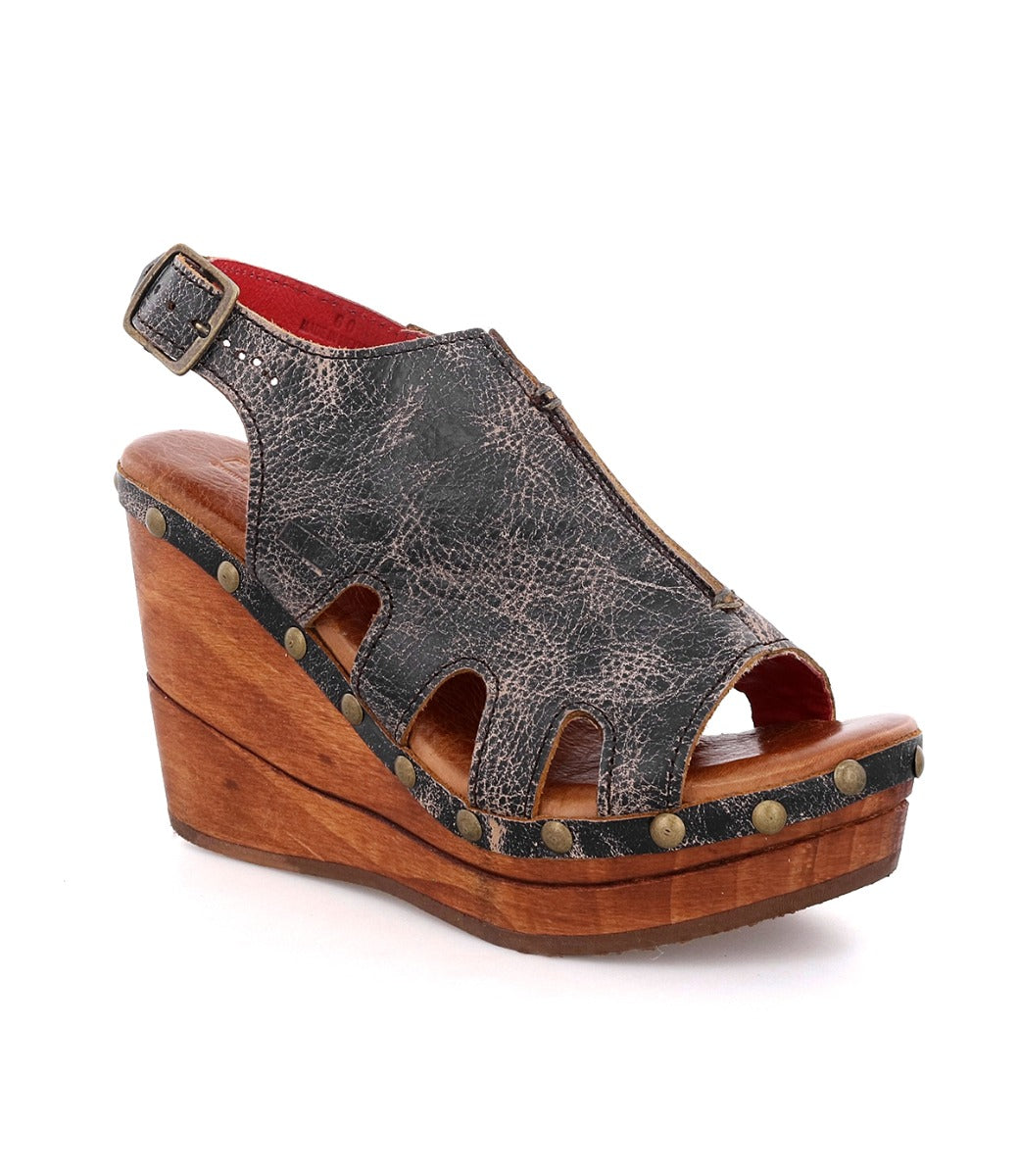 A women's black wedge sandal with a wooden platform by Bed Stu.