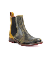 The Nandi by Bed Stu is a distressed leather Chelsea boot featuring yellow accents, a red sole, and elastic side panels, making it perfect for those seeking fashionable women's boots.
