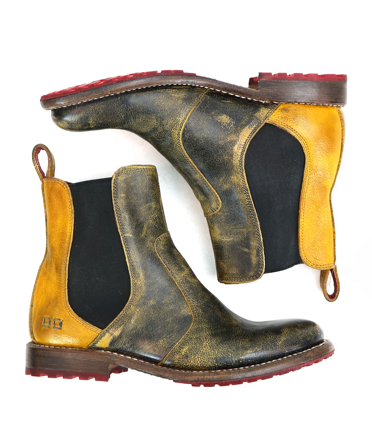 The Nandi women's boots by Bed Stu are distressed leather Chelsea boots in yellow and brown, featuring red soles and convenient pull loops, epitomizing fashion footwear.