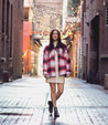 A woman in a plaid jacket standing in an alleyway wearing Nandi by Bed Stu.
