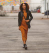 A woman walking down the street wearing Nandi black leather boots.