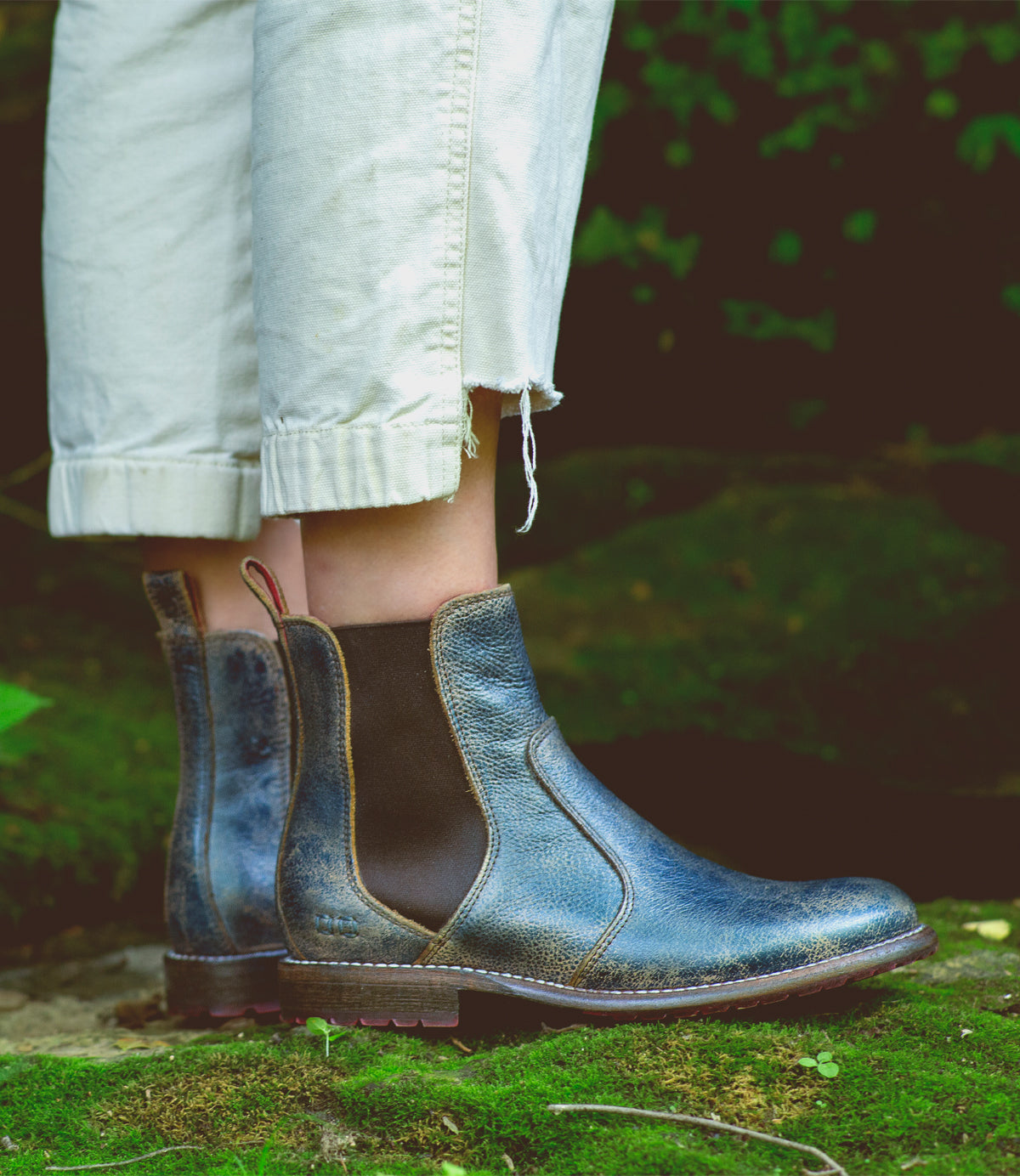 A woman wearing a pair of blue Bed Stu Nandi chelsea boots.