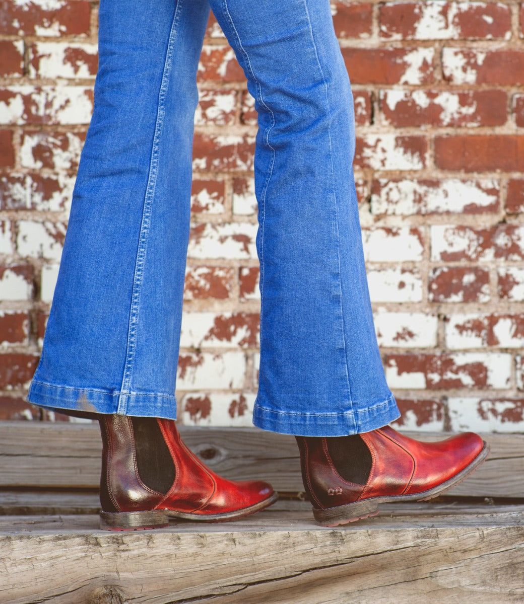 A woman wearing Nandi chelsea boots in cranberry color.