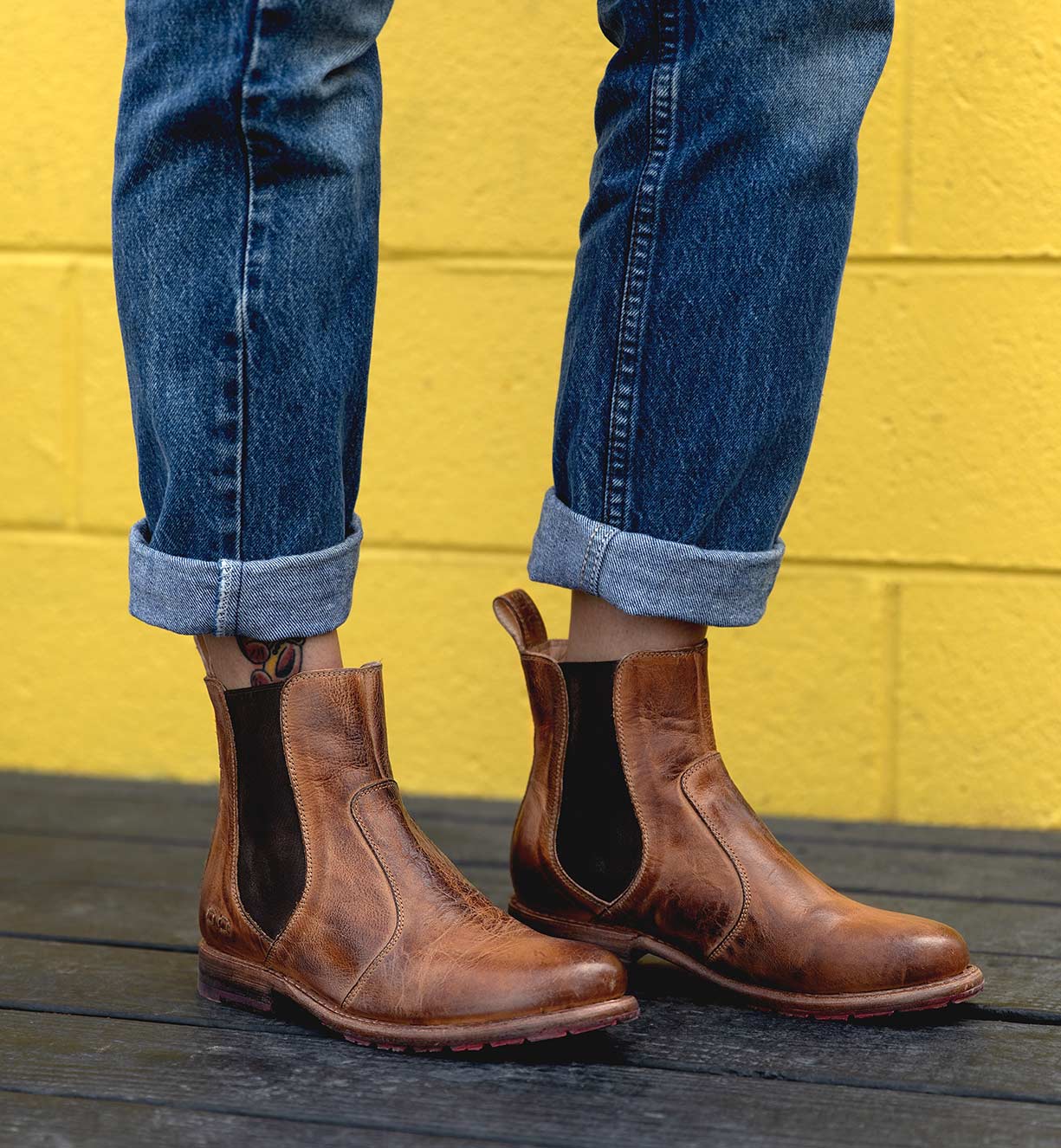 A person wearing Nandi tan pure leather chelsea boots.