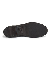A pair of Bed Stu Nando brown leather ankle boots with studs on the sole.