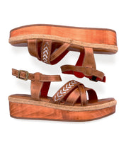 The Bed Stu Necessary sandals feature brown leather, stitched straps, ankle buckles, white stitching accents, and a woven trim around wooden platform soles.