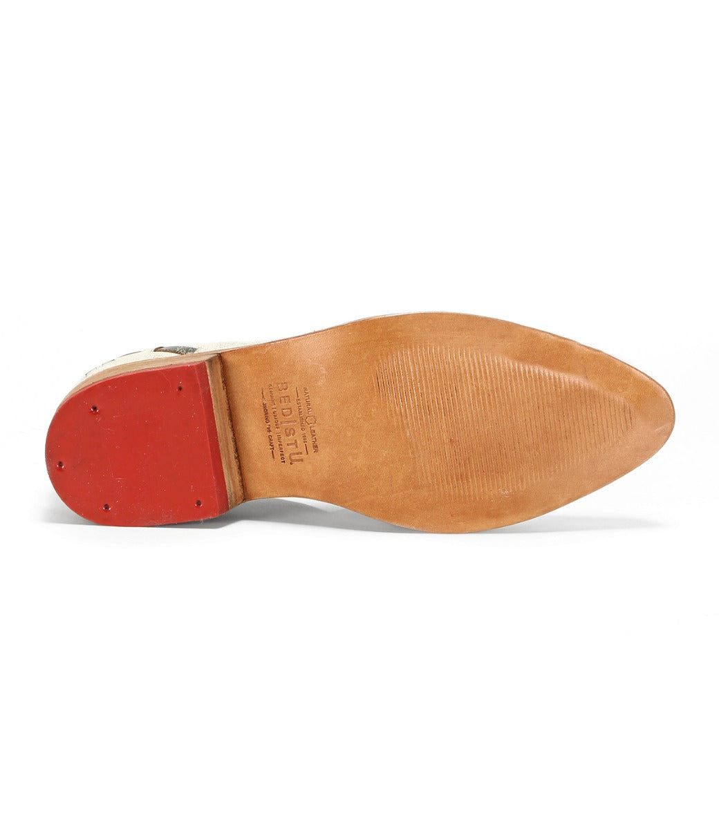 A Neftis shoe with a red sole on a white background by Bed Stu.