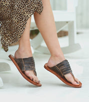 A woman wearing a Nemesis Bed Stu's leather sandals.