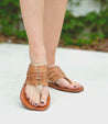 A woman wearing a Nemesis Bed Stu's leather sandals.