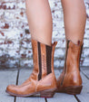 A woman's legs in a pair of Bed Stu Nivi brown boots.