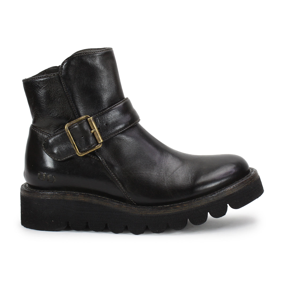 The Bed Stu Nudge II is a black leather ankle boot with a thick ridged sole, adjustable side buckle strap, and slight heel, displayed in left profile against a white background.