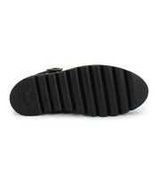 The image shows the bottom view of the Bed Stu Nudge II black ankle boot, featuring a ridged, grooved sole tread and a small rectangular logo near the heel.