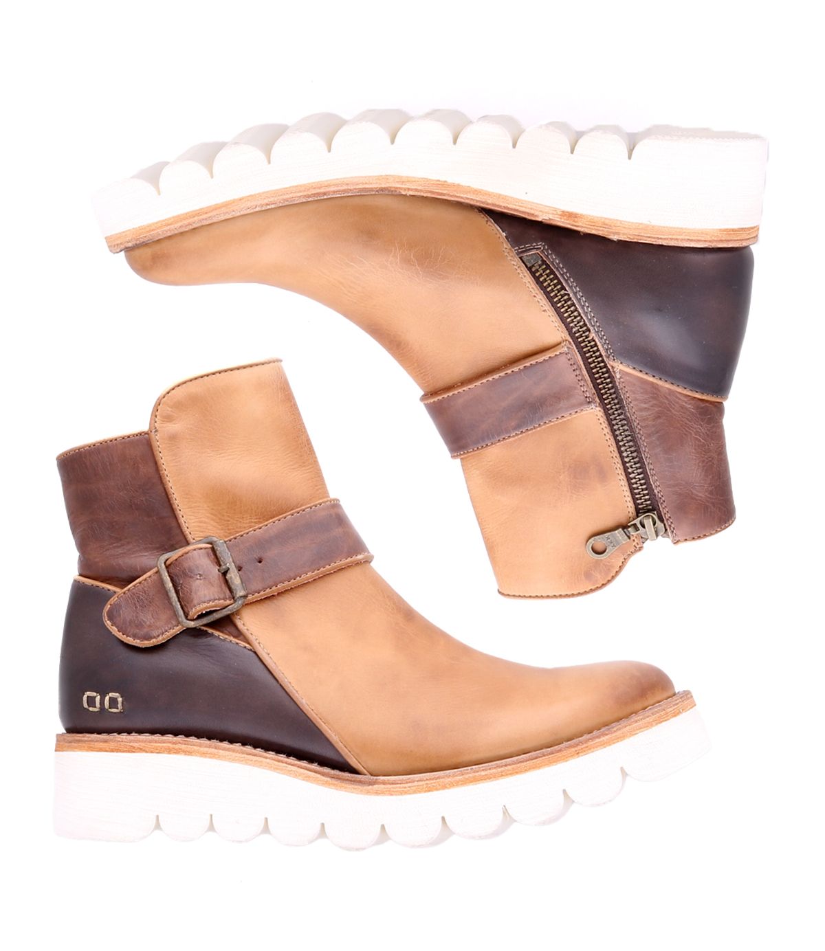 A pair of Bed Stu Nudge II two-tone brown ankle boots with white soles, featuring a side zip and an adjustable strap on each boot. The boots are positioned side by side, facing opposite directions.