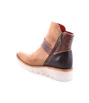 Side view of the Nudge II leather ankle boot by Bed Stu, showcasing its brown and tan color scheme with a white sole, and featuring a convenient side zip for easy on and off.