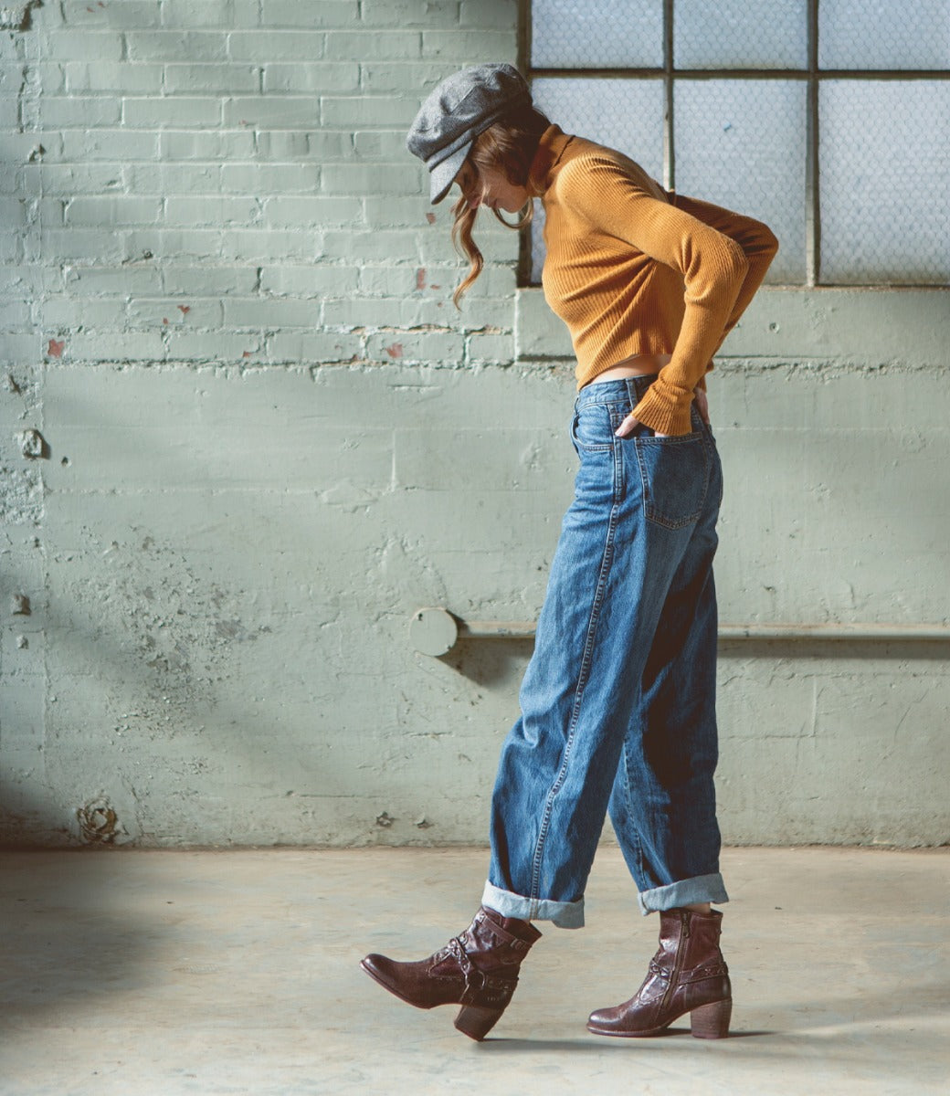 A woman in Bed Stu jeans and Bed Stu boots walking in an industrial space using the Octane II.
