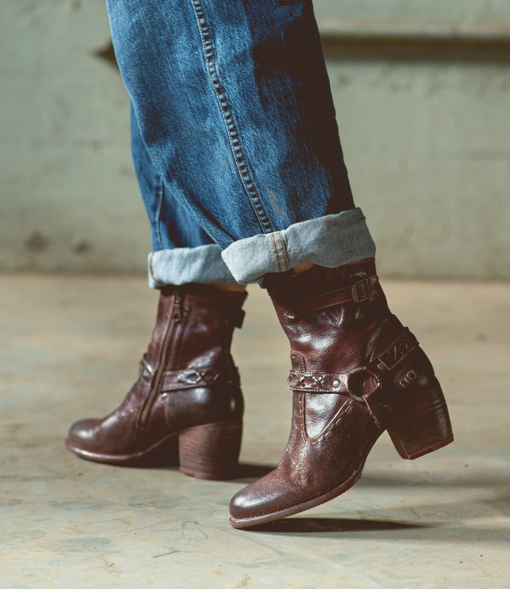 A pair of Bed Stu Octane II brown leather boots on a person's feet.