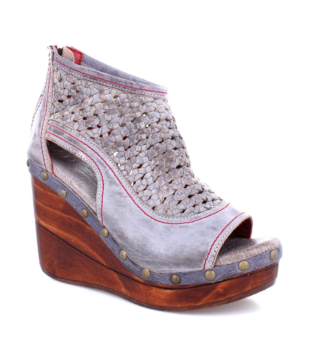 A women's grey wedge sandal with a wooden platform, the Odette by Bed Stu.