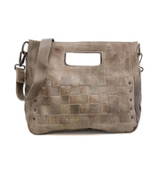 An Orchid Bag from Bed Stu with grey leather, studs, and a handle.