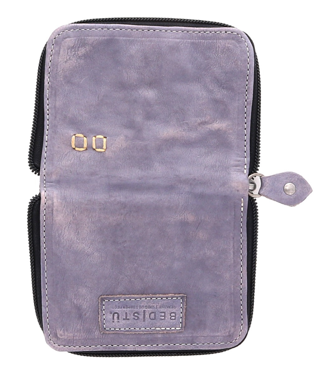 A purple leather Ozzie wallet by Bed Stu with a number on it.