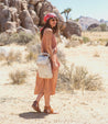 A woman in a tan Patsy dress walking through the desert. (Brand: Bed Stu)