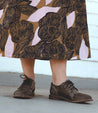 A woman wearing a Plio floral print skirt and Bed Stu brown shoes.