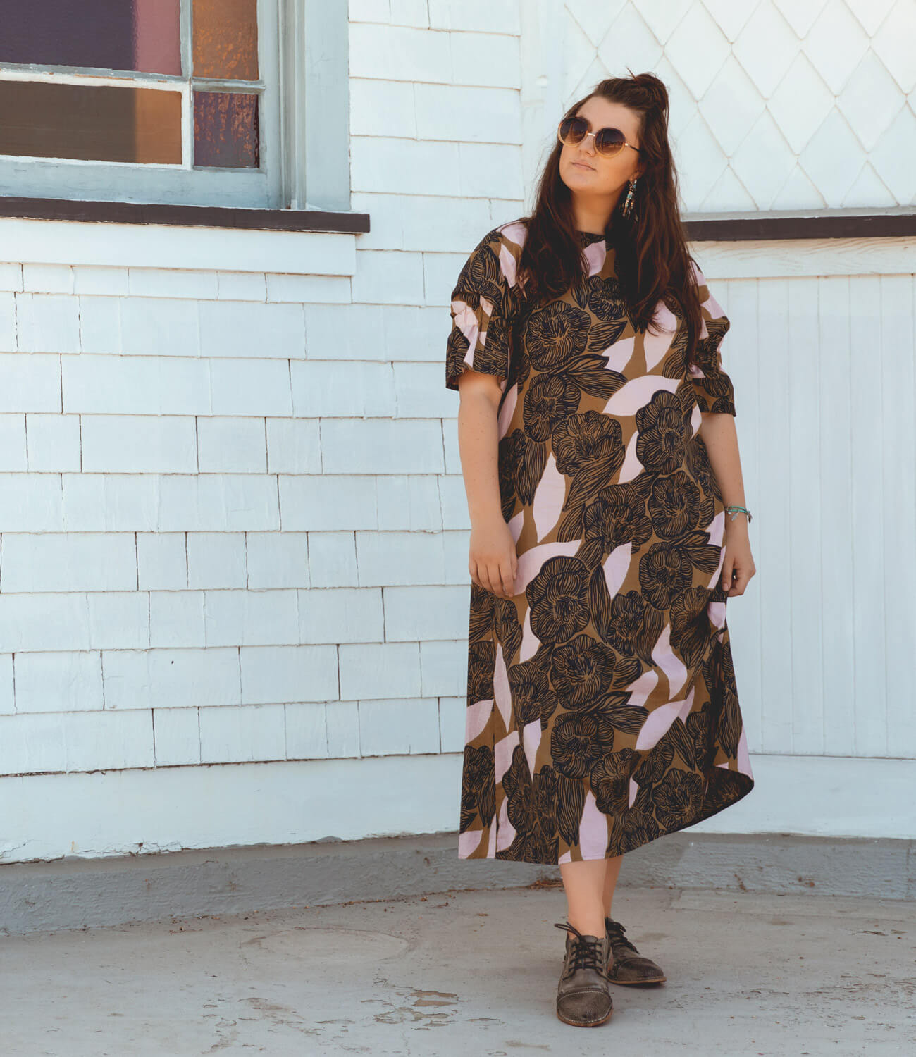 A woman wearing the Bed Stu Plio, a black and brown floral midi dress.