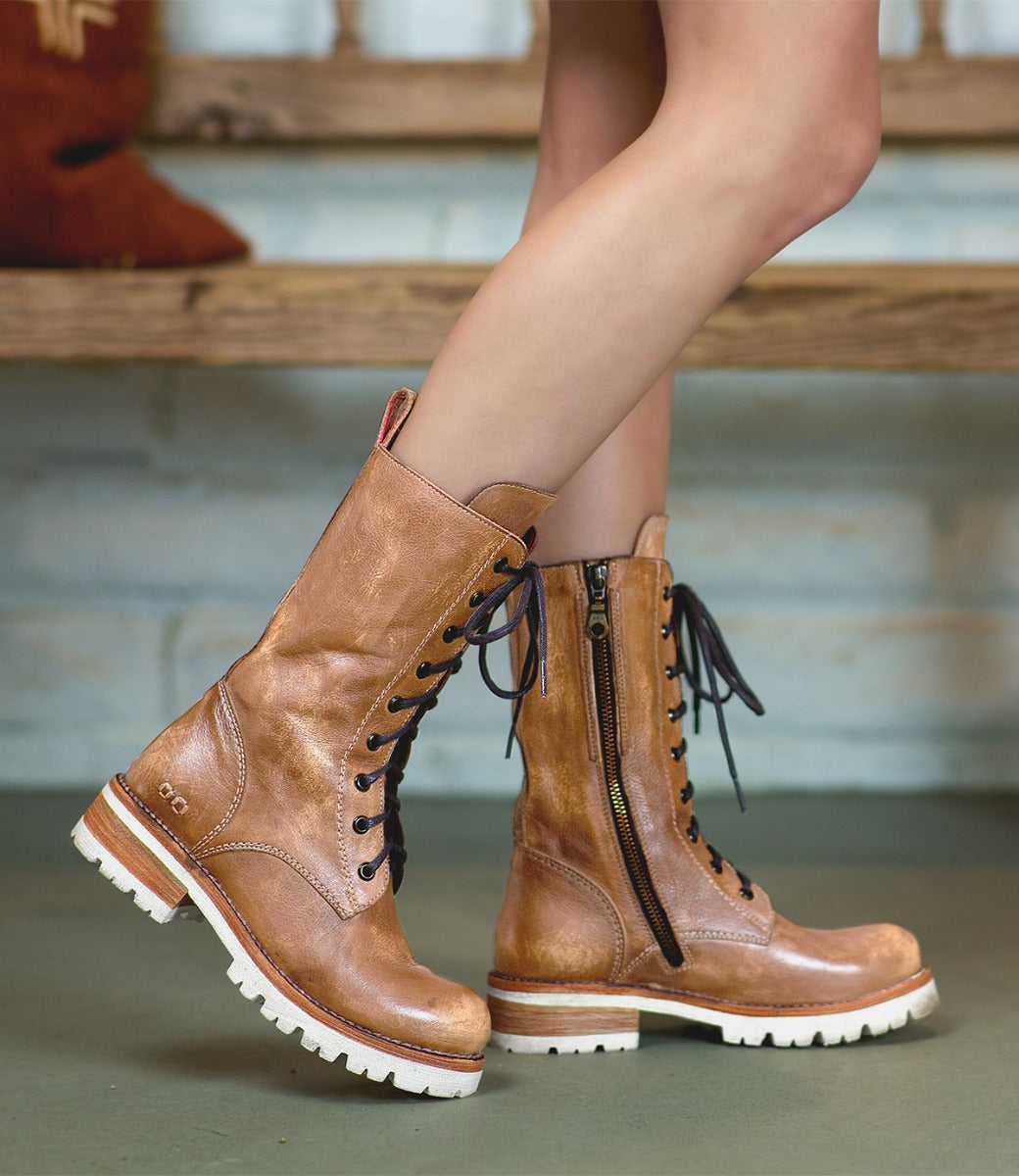 A woman's legs in a pair of Bed Stu Posh boots.