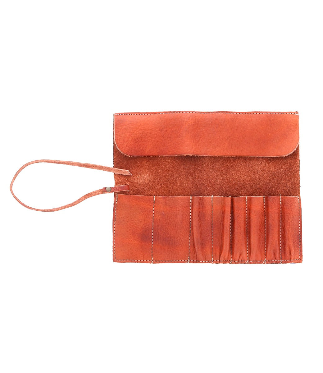 A Prepped by Bed Stu orange leather clutch bag with a handle.