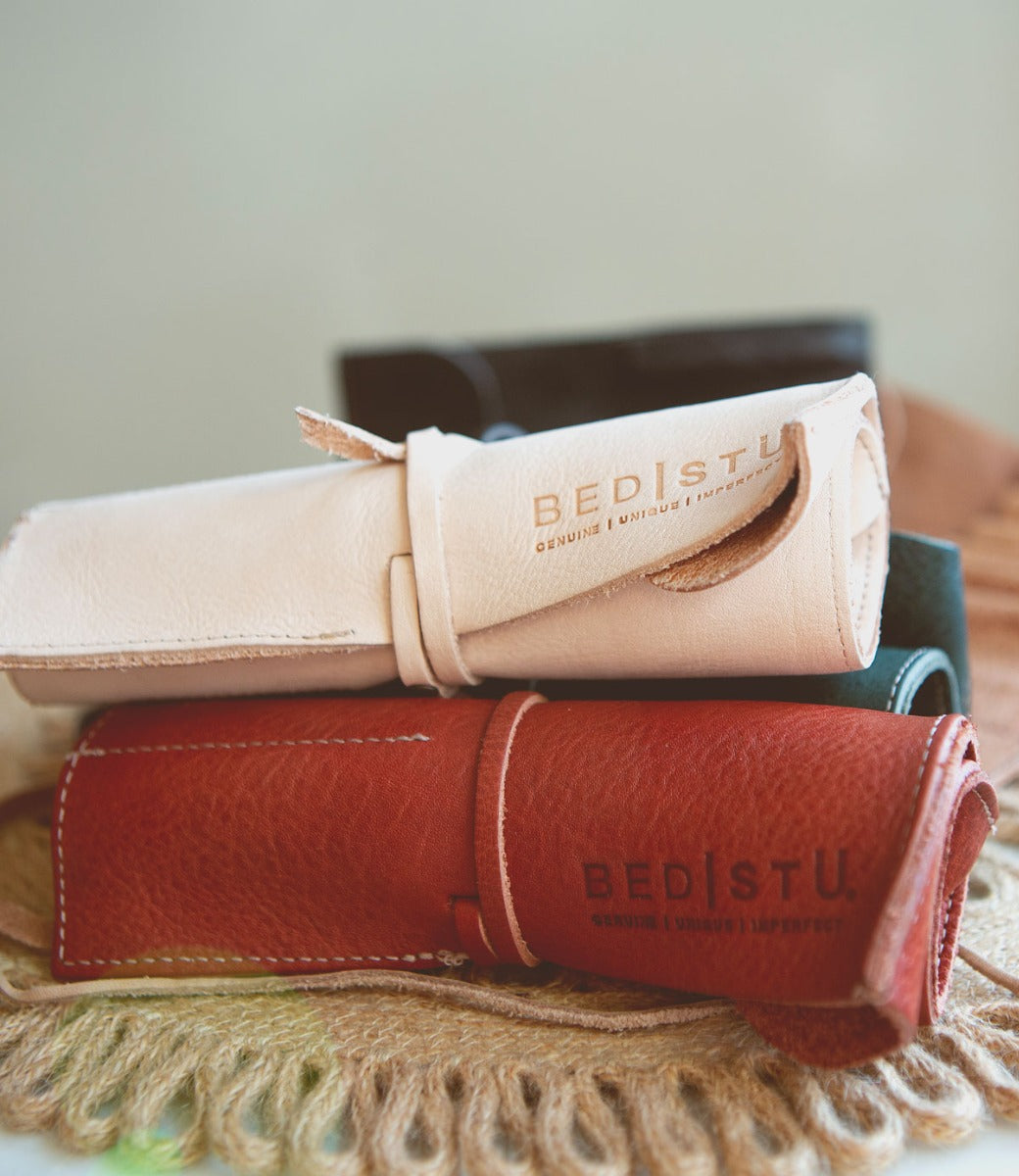 Three different colored Prepped leather pencil cases by Bed Stu on a table.