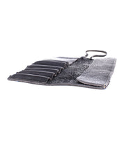 An open black leather Prepped Leather Wrap from Bed Stu, featuring multiple compartments and a secure strap, perfect for organizing artist tools.
