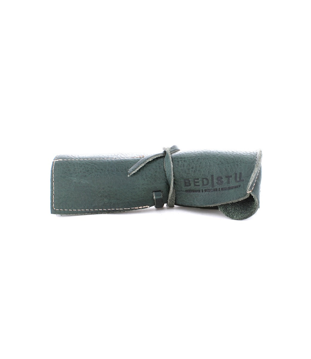 Prepped Leather Wrap from Bed Stu with white stitching, tied with a matching leather strap. Ideal for organizing artist tools, this sophisticated leather wrap offers both style and functionality.