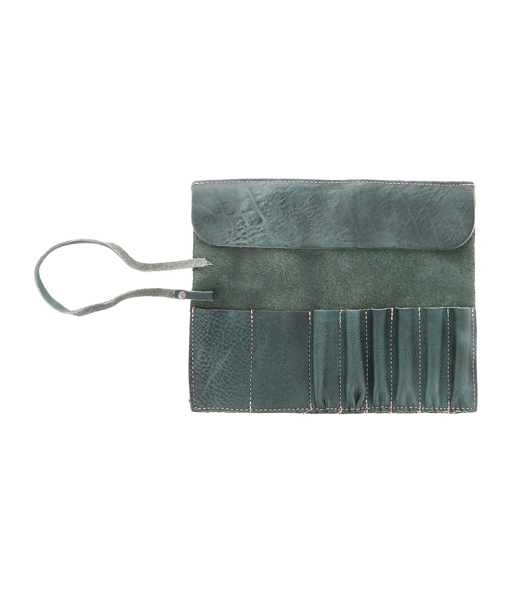 An open, green leather wrap with multiple slim pockets, beige stitching, and a strap closure—perfect for carrying artist tools from Bed Stu's Prepped Leather Wrap.