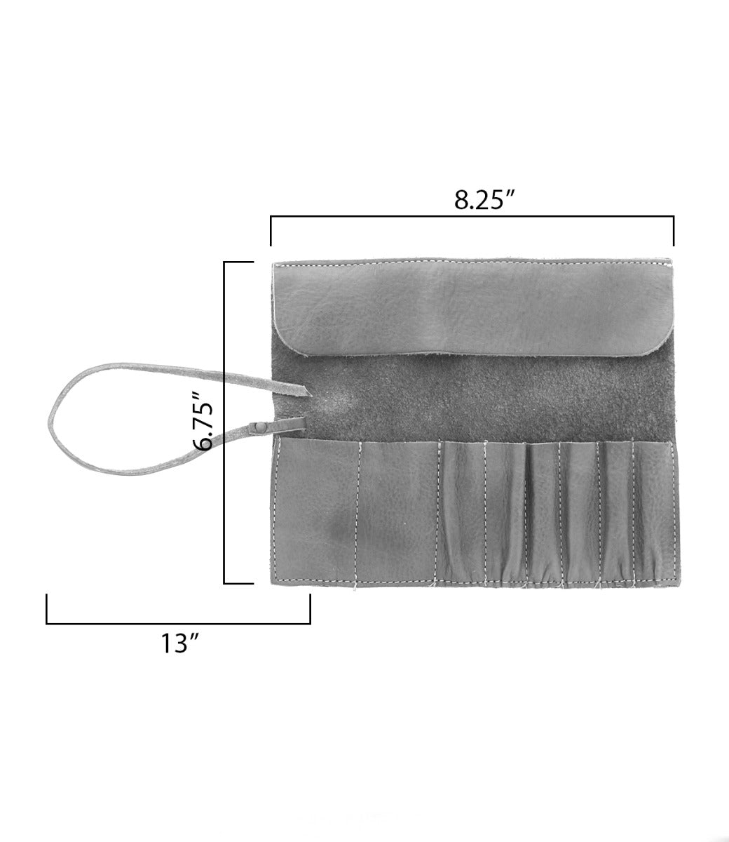 A Prepped Leather Wrap from Bed Stu with dimensions labeled: height 6.75 inches, width 8.25 inches, and length 13 inches. This versatile leather wrap has multiple slots for artist tools and a strap for securing it closed.