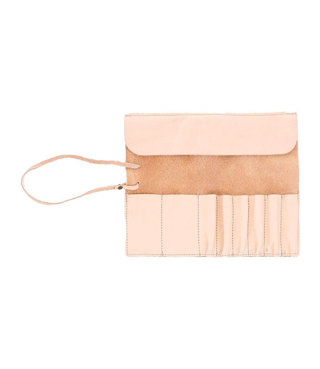 A tan leather wrap from the Leather Shoppe, featuring multiple compartments and a strap closure, perfect for holding artist tools or brushes.

Revised: The Prepped Leather Wrap from Bed Stu, featuring multiple compartments and a strap closure, perfect for holding artist tools or brushes.