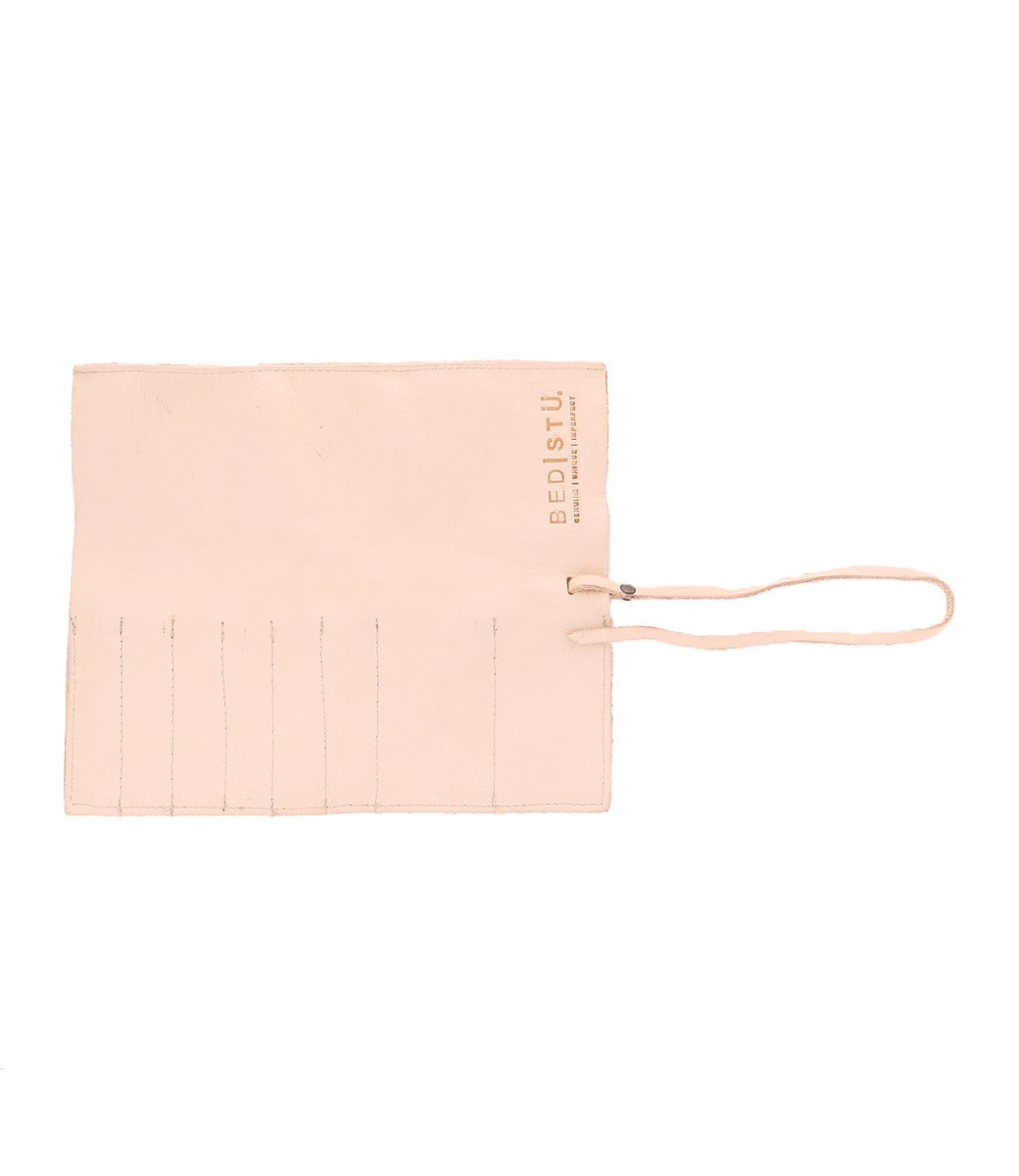 A flat, beige leather wrap with multiple slots and a tied strap closure perfect for artist tools. The brand name "Bed Stu" is stamped on it, showcasing the quality craftsmanship of our Prepped Leather Wrap.