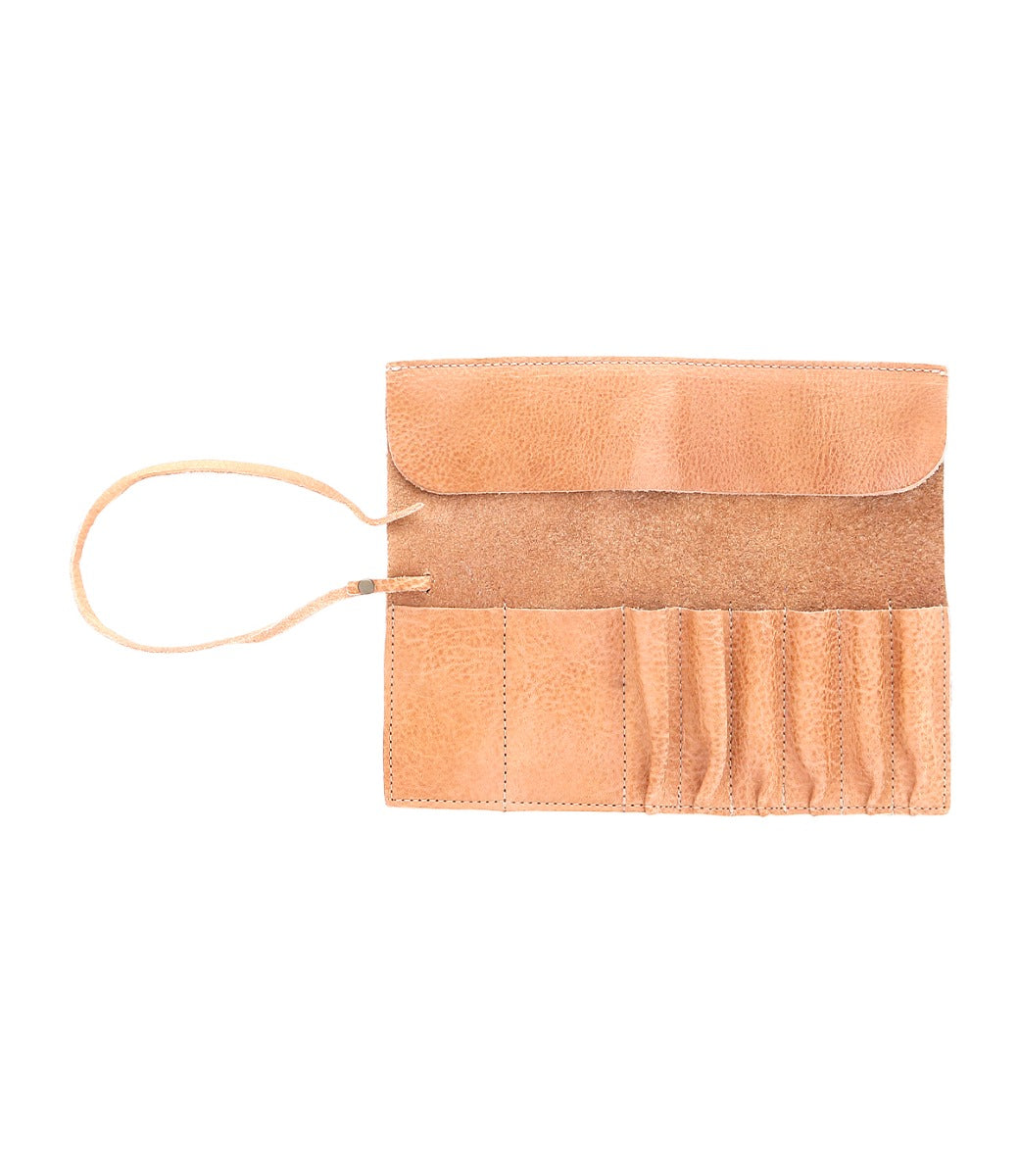 An open Prepped Leather Wrap from Bed Stu, featuring multiple pockets for artist tools and a strap on the left side.