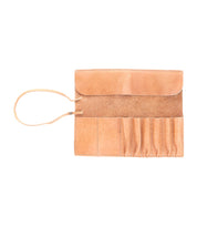 An open Prepped Leather Wrap from Bed Stu, featuring multiple pockets for artist tools and a strap on the left side.