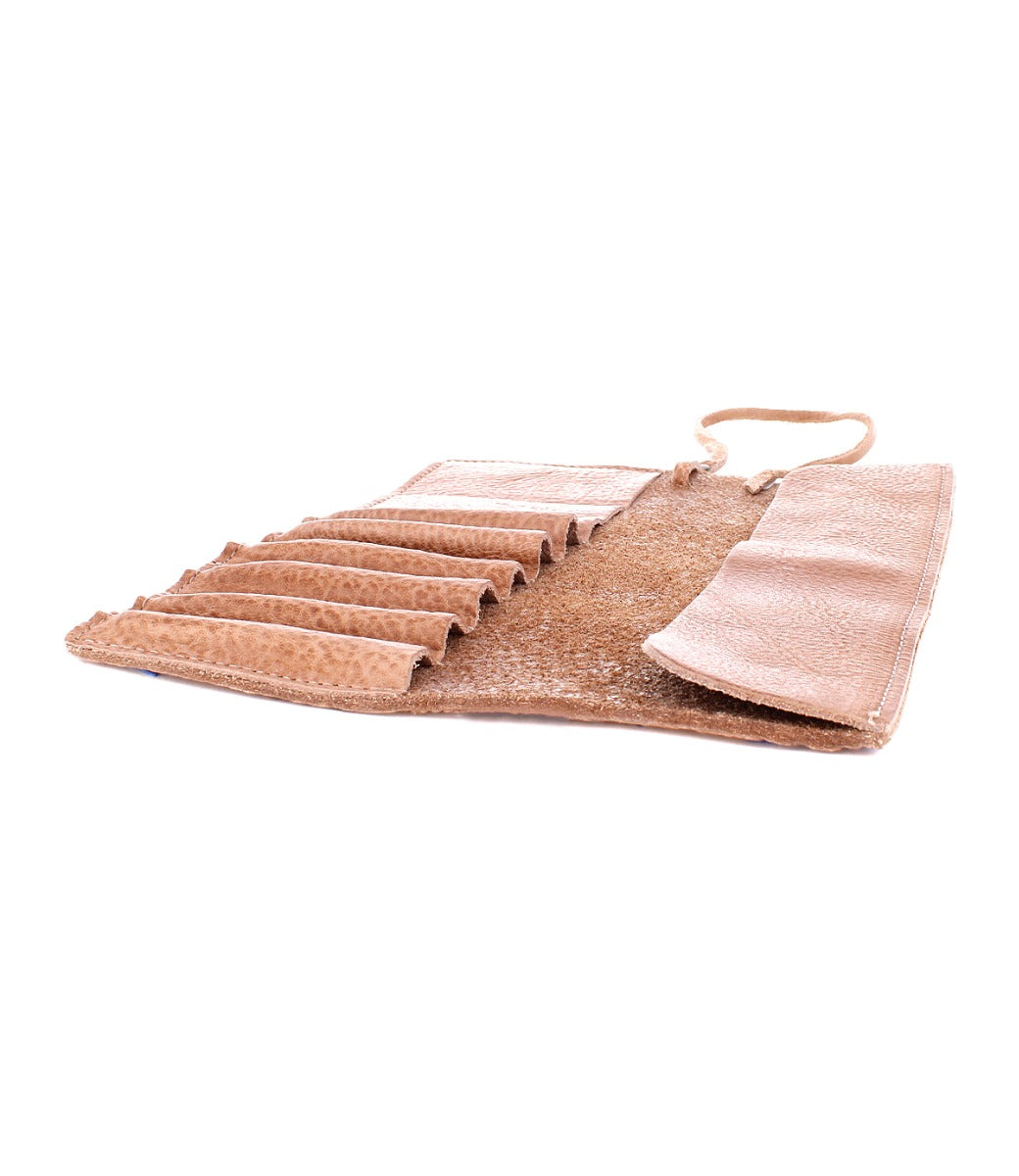 An open Prepped Leather Wrap from Bed Stu, featuring multiple slots for holding artist tools or accessories, lying flat on a white background.