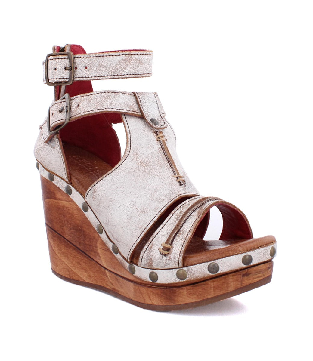 A women's white wedge sandal with a wooden platform, called Princess by Bed Stu.