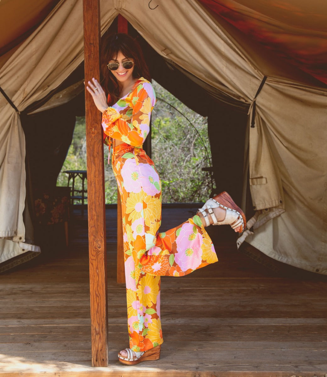 A woman in a floral jumpsuit wearing Bed Stu Princess.