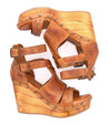 A pair of Bed Stu Princess wedge sandals with straps and buckles.