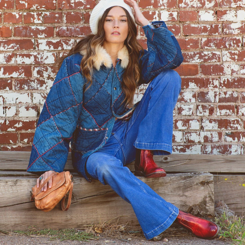 A woman in denim jacket and jeans wearing a Priscilla bag by Bed Stu.