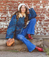 A woman in denim jacket and jeans wearing a Priscilla bag by Bed Stu.