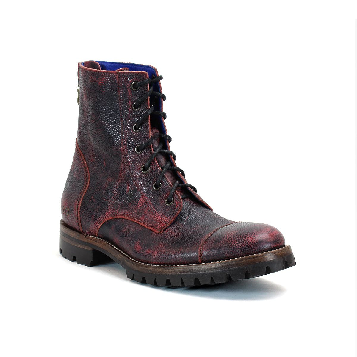 A single Protege Trek boot by Bed Stu, featuring red and black leather lace-up details and a rugged Vibram outsole, is shown against a white background, epitomizing the combat style boot aesthetic.